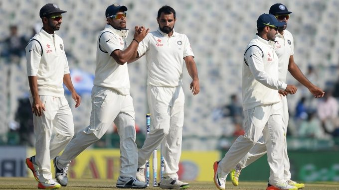 India's bowler Mohd Shami (3R) celebrates with his teammates after he dismissed England's batsman Moeen Ali during the first day of the third Test cricket match between India and England at The Punjab Cricket Association Stadium in Mohali on November 26, 2016. / AFP PHOTO / SAJJAD HUSSAIN / ----IMAGE RESTRICTED TO EDITORIAL USE - STRICTLY NO COMMERCIAL USE----- / GETTYOUT