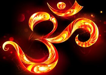 Patterned ohm symbol from bright flame on black background.