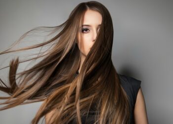 Portrait of calm emotionless model with long windy hair.Studio shot.