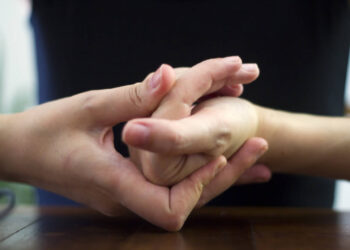Woman cracking their knuckles, close up
