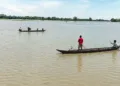 Majuli [Assam], Jul 14 (ANI): Locals make their way by boats through a flood-affected area as the water level of the Subansiri River rises due to the opening of NHPC Dam gates near the Majuli-Lakhimpur border, in Majuli on Tuesday. (ANI Video Grab)